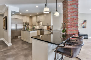 Modern luxury kitchen with brick accent and island seating
