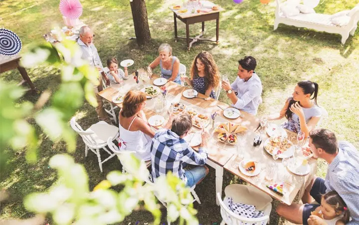 family having lunch in their home garden